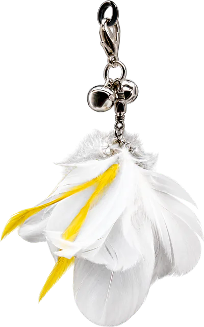 PURRZ™ Jingle Jangle attachment in Cockatoo Chaos: a bunch of white feathers with yellow strands, hanging under two silver bells from a clip